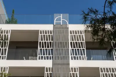 a white building with whiteadders on the side of it at Athens Hill Luxury Apartments in Athens