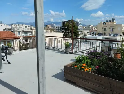 a view of a balcony with flowers in a planter at Roofgarden Apartment in Athens