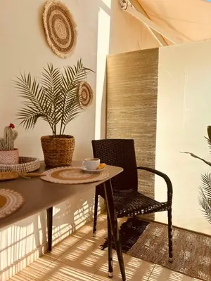 a table and chair in a room with a plant at Central & Comfortable, with Acropolis view in Athens