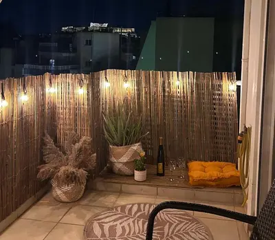 a balcony with a bed and a window with lights at Central & Comfortable, with Acropolis view in Athens
