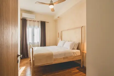 a bedroom with a bed and a ceiling fan at Luxury Apartment with Acropolis View Terrace and Jacuzzi - Living Stone Moonstone in Athens