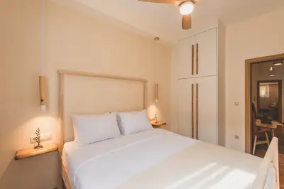 a bedroom with a white bed and a desk at Luxury Apartment with Acropolis View Terrace and Jacuzzi - Living Stone Moonstone in Athens