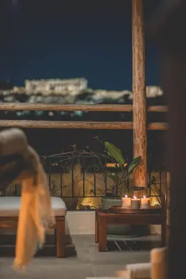 a table with candles and a potted plant on a balcony at Luxury Apartment with Acropolis View Terrace and Jacuzzi - Living Stone Moonstone in Athens