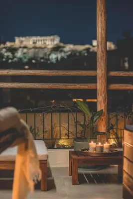 a balcony with a table with candles on it at Luxury Apartment with Acropolis View Terrace and Jacuzzi - Living Stone Moonstone in Athens