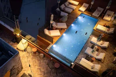 an overhead view of a swimming pool in a building at Anise Aluma Athens, Tapestry Collection by Hilton in Athens
