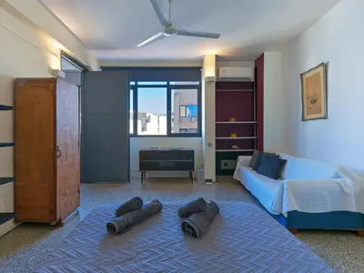 a bedroom with a bed and a blue rug at Eastern Aromas loft in Psyri, Athens in Athens