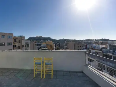two yellow chairs sitting on top of a balcony at Eastern Aromas loft in Psyri, Athens in Athens