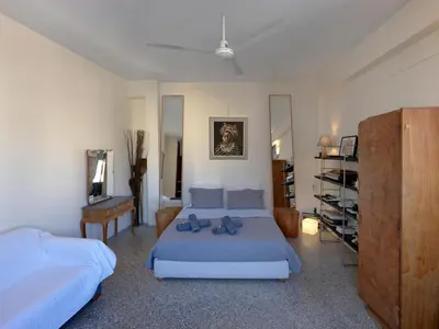a bedroom with two beds and a dresser in it at Eastern Aromas loft in Psyri, Athens in Athens