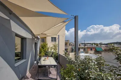 a patio with a table on a balcony at Sunny Loft with Acropolis View in Athens