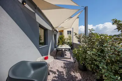 a patio with a chair and a table on a building at Sunny Loft with Acropolis View in Athens
