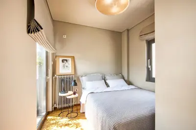 a bedroom with a bed and a window at Sunny Loft with Acropolis View in Athens