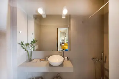 a bathroom with a sink and a mirror at Sunny Loft with Acropolis View in Athens
