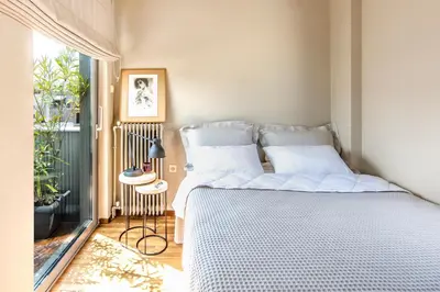 a bedroom with a bed and a large window at Sunny Loft with Acropolis View in Athens