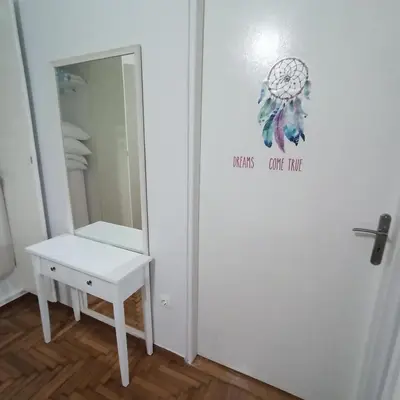 a bathroom with a mirror and a white table at Chrishome in Athens