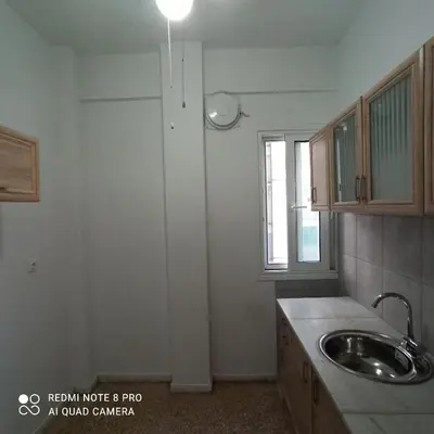 a kitchen with a sink and a window at Chrishome in Athens