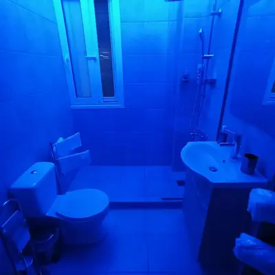 a bathroom with a white toilet and a sink at Chrishome in Athens