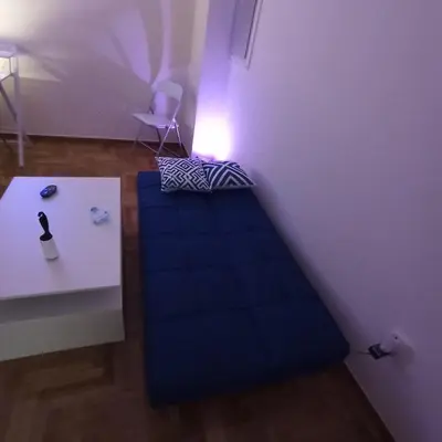 a small room with a bed and a table at Chrishome in Athens