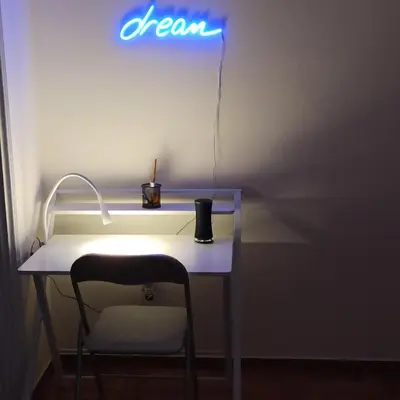 a desk with a chair and a sign that says dream at Chrishome in Athens