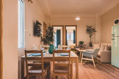 a kitchen and living room with a table and chairs at Luxury Apartment with Acropolis view Terrace and Jacuzzi in the Heart of Athens - Living Stone Azurite in Athens
