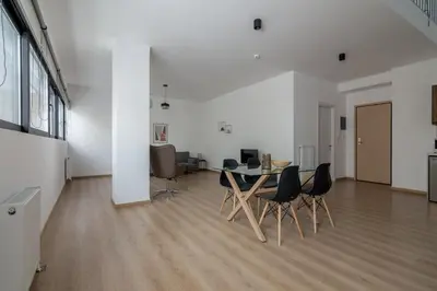 a white room with a table and chairs in it at Leochares Lifestyle Apartments - Self check-in in Athens