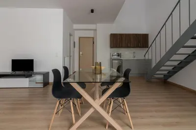 a dining room with a glass table and black chairs at Leochares Lifestyle Apartments - Self check-in in Athens