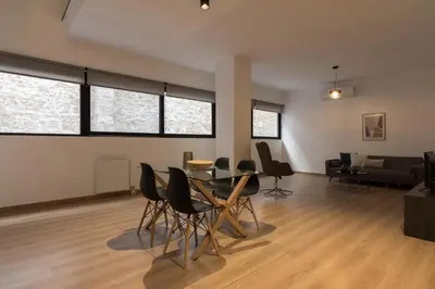 a living room with a table and chairs at Leochares Lifestyle Apartments - Self check-in in Athens