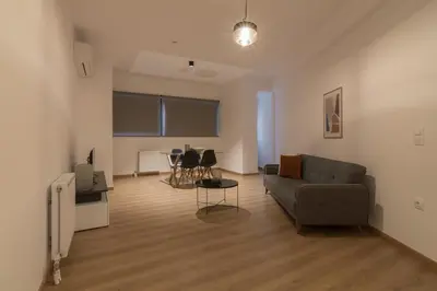 a living room with a couch and a table at Leochares Lifestyle Apartments - Self check-in in Athens
