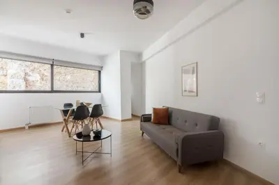 a living room with a couch and a table at Leochares Lifestyle Apartments - Self check-in in Athens