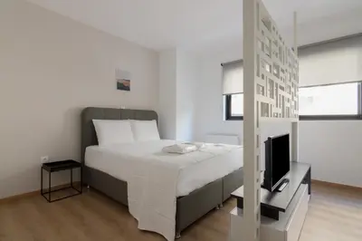 a bedroom with a bed and a television at Leochares Lifestyle Apartments - Self check-in in Athens