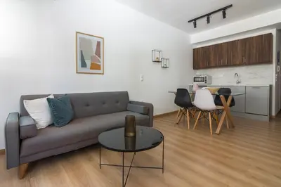 a living room with a couch and a table at Leochares Lifestyle Apartments - Self check-in in Athens
