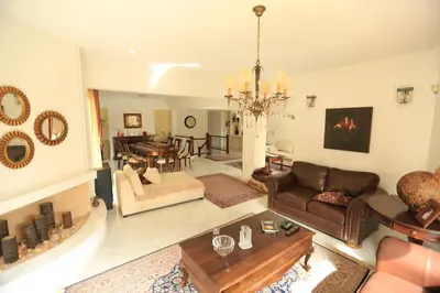 a living room with a couch and a table at In White Villa in Lagonissi