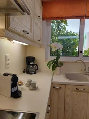 a kitchen counter with a sink and a window at In White Villa in Lagonissi