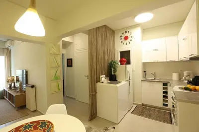 a kitchen with white cabinets and a white refrigerator at Boutique17 Luxury Apartment 2nd floor in Athens