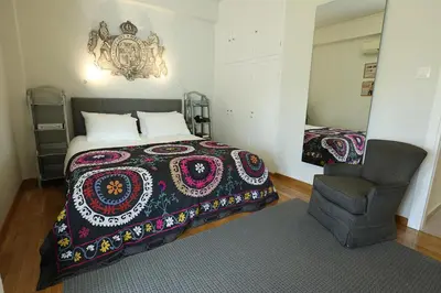 a bedroom with a bed and a chair at Boutique17 Luxury Apartment 2nd floor in Athens