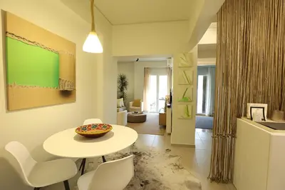 a living room with a table and white chairs at Boutique17 Luxury Apartment 2nd floor in Athens