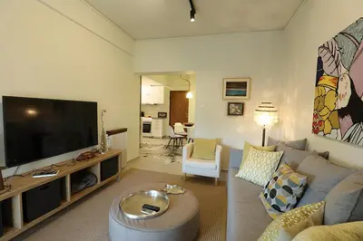 a living room with a couch and a flat screen tv at Boutique17 Luxury Apartment 2nd floor in Athens
