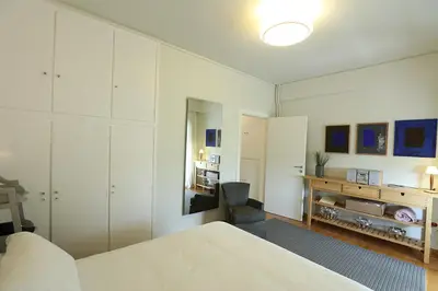 a white bedroom with a bed and a desk at Boutique17 Luxury Apartment 2nd floor in Athens