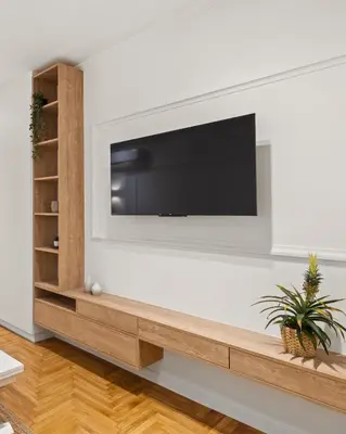 a living room with a flat screen tv on a wall at Little Athens in Athens