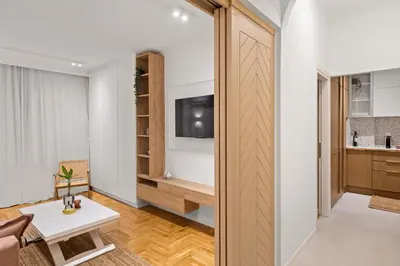 a room with a door leading to a living room with a tv at Little Athens in Athens