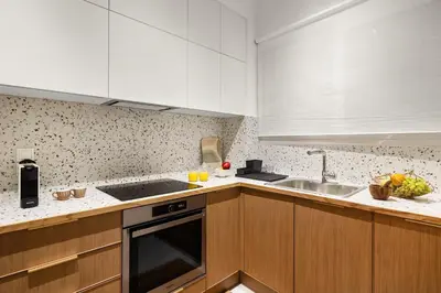a kitchen with white cabinets and a sink at Little Athens in Athens