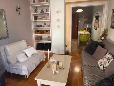 a living room with a couch and a coffee table at Kouklospito Cozy City Apartment in Kallithea Athens in Athens