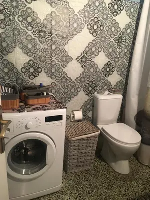 a bathroom with a washing machine and a toilet at Kouklospito Cozy City Apartment in Kallithea Athens in Athens
