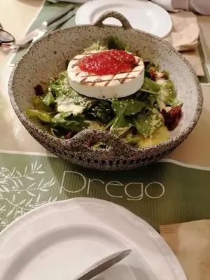 a bowl of salad with an egg on top of it at Kouklospito Cozy City Apartment in Kallithea Athens in Athens