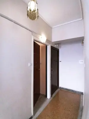an empty hallway with a door and a chandelier at Athens Neoclassical in Athens