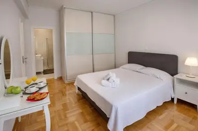 a bedroom with a bed and a table with a plate of fruit at Upscale Luxury Athens Renovated Dream Home in One of the most Favorable Locations by National Gardens, Zoo & Hellenic Parliament in Syntagma and Stylish Exquisite Kolonaki neighborhood in Athens