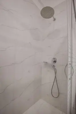 a bathroom with a shower with a shower head at Upscale Luxury Athens Renovated Dream Home in One of the most Favorable Locations by National Gardens, Zoo & Hellenic Parliament in Syntagma and Stylish Exquisite Kolonaki neighborhood in Athens