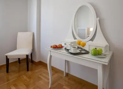 a dressing table with a mirror and a plate of fruit at Upscale Luxury Athens Renovated Dream Home in One of the most Favorable Locations by National Gardens, Zoo & Hellenic Parliament in Syntagma and Stylish Exquisite Kolonaki neighborhood in Athens