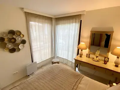 a bedroom with a bed and a mirror and a window at Amazing Garden House in Athens