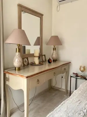 a dressing table with two lamps and a mirror at Amazing Garden House in Athens