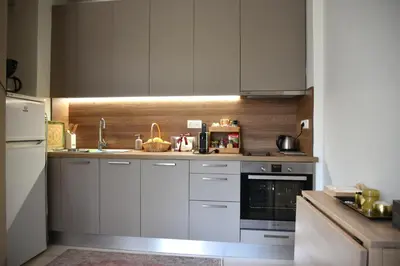 a kitchen with white cabinets and a sink at Amazing Garden House in Athens